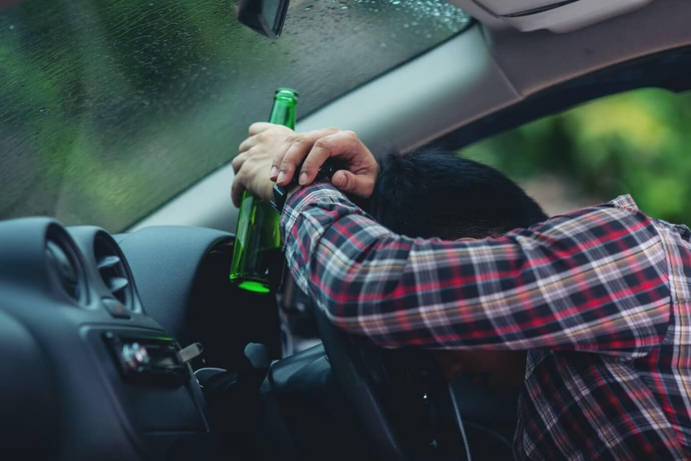 Visual portrayal of a man visibly impaired inside his car, spotlighting R&G Personal Injury Lawyers and their specialization in legal matters related to drunk driving. The image is contextually aligned with the page, emphasizing the firm's expertise as Drunk Driver Lawyers.