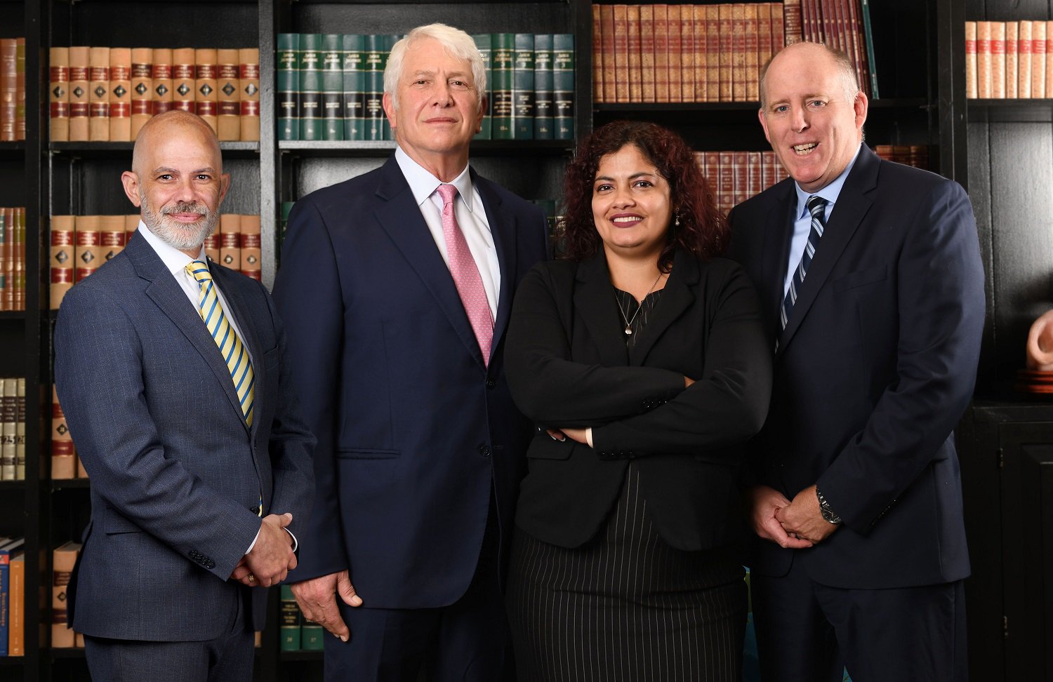 Group photo capturing three men and one woman, prominently featuring the professionals from R&G Personal Injury Lawyers. The image emphasizes the firm's brand with the text 'R&G PERSONAL INJURY LAWYERS,' aligning seamlessly with the context of the page.