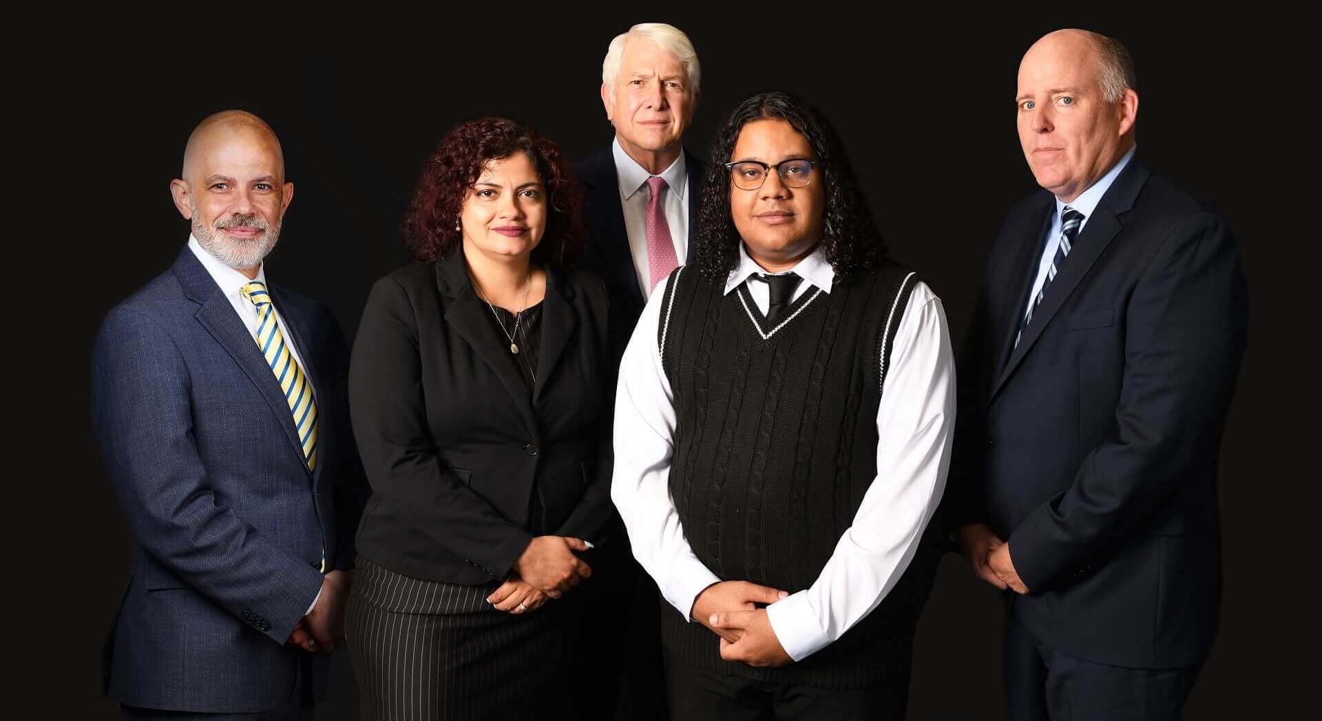 Portrait of a diverse group consisting of four men and one woman, showcasing the professionals from R&G Personal Injury Lawyers. The image underscores the prominence of the firm in the field of Personal Injury Law, emphasizing expertise and commitment, aligning seamlessly with the informative context of the page.